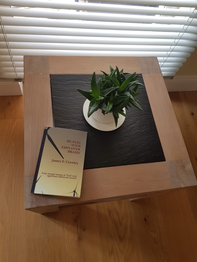 Re-Fuel Your Employer Brand by James E Crawley on a wooden table